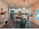 Modern kitchen with stainless steel appliances, an island, and a dining area with hardwood floors at 126 Jacobs Ln, Loganville, GA 30052