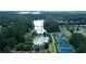 Aerial shot features a community pool, lake, tennis courts, and clubhouse near lush trees and homes at 615 Brookwater Dr, Stockbridge, GA 30281