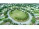 Aerial shot showcases a large community green space ringed by homes in a suburban neighborhood at 615 Brookwater Dr, Stockbridge, GA 30281