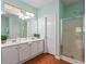Bathroom showcasing double sinks, a walk-in shower, and ample natural light at 615 Brookwater Dr, Stockbridge, GA 30281