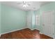 Light-filled bedroom with hardwood flooring, neutral walls, and a ceiling fan at 615 Brookwater Dr, Stockbridge, GA 30281