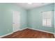 Cozy bedroom with hardwood floors, white trim, and a window with shutters at 615 Brookwater Dr, Stockbridge, GA 30281