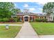 Community clubhouse with manicured lawns, elegant brick facade, and inviting entrance at 615 Brookwater Dr, Stockbridge, GA 30281