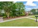 Beautiful clubhouse exterior with lush landscaping, manicured lawns, and a sidewalk leading to the entrance at 615 Brookwater Dr, Stockbridge, GA 30281