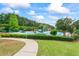 Spacious community pool with various seating arrangements, surrounded by lush greenery and mature trees at 615 Brookwater Dr, Stockbridge, GA 30281