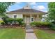Charming home with inviting front porch, well-maintained landscaping, and stone walkway at 615 Brookwater Dr, Stockbridge, GA 30281