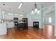 Open concept kitchen with an island, fireplace and stainless steel appliances, seamlessly connecting to the living area at 615 Brookwater Dr, Stockbridge, GA 30281