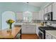 Bright kitchen featuring white cabinets, stainless steel appliances, and a mosaic backsplash at 615 Brookwater Dr, Stockbridge, GA 30281