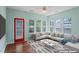 Staged sunroom with hardwood flooring, stylish furniture, and lots of windows at 615 Brookwater Dr, Stockbridge, GA 30281