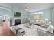 Staged living room featuring a fireplace, high ceilings, and bright windows at 615 Brookwater Dr, Stockbridge, GA 30281