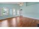 Open living room with hardwood floors, bright windows, and access to the backyard at 615 Brookwater Dr, Stockbridge, GA 30281