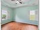 Primary bedroom with tray ceilings, wood flooring, and two windows at 615 Brookwater Dr, Stockbridge, GA 30281