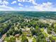 Scenic aerial view of a community surrounded by lush trees, featuring well-spaced homes at 625 Hickory Nobb, Sugar Hill, GA 30518