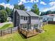 Beautiful backyard with a wood deck, mature trees, and a well-kept lawn at 625 Hickory Nobb, Sugar Hill, GA 30518
