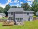 Charming backyard showcasing a well-maintained lawn, wood deck, and two-story home at 625 Hickory Nobb, Sugar Hill, GA 30518