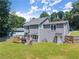 Spacious backyard featuring a two-story home, wood deck, and lush green lawn at 625 Hickory Nobb, Sugar Hill, GA 30518