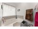 Bathroom with a tub, decor, and window with lots of natural light at 625 Hickory Nobb, Sugar Hill, GA 30518