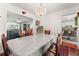 Formal dining room featuring a chandelier, hardwood floors, and access to the kitchen and living area at 625 Hickory Nobb, Sugar Hill, GA 30518