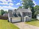 Two-story home featuring a two-car garage, and well-kept front lawn at 625 Hickory Nobb, Sugar Hill, GA 30518