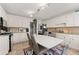 Bright kitchen with white cabinets, stainless steel appliances, and an eat-in area at 625 Hickory Nobb, Sugar Hill, GA 30518
