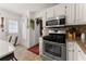 Bright kitchen with stainless steel oven, tile floors, and access to the backyard at 625 Hickory Nobb, Sugar Hill, GA 30518