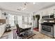 Eat-in kitchen with stainless steel appliances, white cabinets, and modern lighting at 625 Hickory Nobb, Sugar Hill, GA 30518