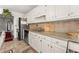 Well-lit kitchen featuring granite countertops, stainless steel appliances, and tile flooring at 625 Hickory Nobb, Sugar Hill, GA 30518