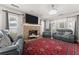 Spacious living room featuring a stone fireplace, hardwood floors, and stylish furnishings at 625 Hickory Nobb, Sugar Hill, GA 30518