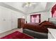 Main bedroom featuring a bed, dark wood dresser, tray ceiling, and an area rug at 625 Hickory Nobb, Sugar Hill, GA 30518