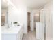 Modern bathroom featuring double sinks, a glass-enclosed shower, and tiled flooring at 2453 Honey Way, Conyers, GA 30013