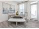 Dining room features modern decor, a large window, and a dining table with seating for six at 2453 Honey Way, Conyers, GA 30013
