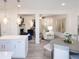 Open concept kitchen with island and pendant lights, dining area, and living area at 2453 Honey Way, Conyers, GA 30013