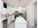 Contemporary kitchen with stainless steel appliances, white cabinets, a kitchen island and modern lighting at 2453 Honey Way, Conyers, GA 30013
