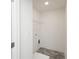 Compact laundry room with gray tile flooring, white walls and trim, and shelving at 2453 Honey Way, Conyers, GA 30013