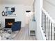 Cozy living room featuring a fireplace, decorative decor, and a staircase at 2453 Honey Way, Conyers, GA 30013