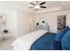 This spacious bedroom features a ceiling fan, sitting area, and large bed with stylish blue bedding at 2453 Honey Way, Conyers, GA 30013