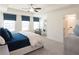 This stylish bedroom features blue window treatments, a ceiling fan, and sitting area at 2453 Honey Way, Conyers, GA 30013