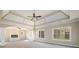 Large main bedroom with carpet, tray ceiling, and fireplace at 2571 Se Ebenezer Rd, Conyers, GA 30094