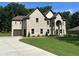 Charming brick home with an attached garage and a well-maintained front yard at 2571 Se Ebenezer Rd, Conyers, GA 30094