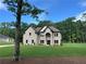 Picturesque brick home with a lush green lawn and mature trees at 2571 Se Ebenezer Rd, Conyers, GA 30094