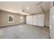 Spacious garage with two windows, a white garage door, and a water heater at 2571 Se Ebenezer Rd, Conyers, GA 30094