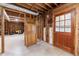 Unfinished basement space with exposed framing and access to the backyard at 5826 Andover Way, Tucker, GA 30084