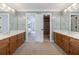 Bathroom with double sinks and mirrors, open door to main bedroom and a walk-in shower at 5826 Andover Way, Tucker, GA 30084