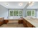 Primary bathroom featuring a soaking tub, double sinks and a large window overlooking a wooded backyard at 5826 Andover Way, Tucker, GA 30084