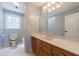 Bathroom featuring a toilet, shower/tub combo, and single sink vanity with neutral color palette at 5826 Andover Way, Tucker, GA 30084
