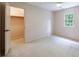 Empty bedroom featuring a closet and window with outside views at 5826 Andover Way, Tucker, GA 30084