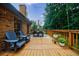 Inviting backyard deck with brick, outdoor dining, and blue chairs for relaxation and entertaining in a private setting at 5826 Andover Way, Tucker, GA 30084