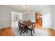 Traditional dining room with hardwood floors, wainscoting, and a view to the kitchen at 5826 Andover Way, Tucker, GA 30084