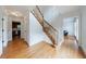 Bright foyer featuring hardwood floors, a staircase with wood banister, and white trim at 5826 Andover Way, Tucker, GA 30084