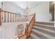 Bright foyer with staircase, chandelier, and ornate glass front door, creating an inviting entrance at 5826 Andover Way, Tucker, GA 30084